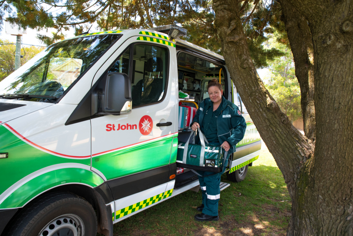 An image of Beth T  in front of an ambulance