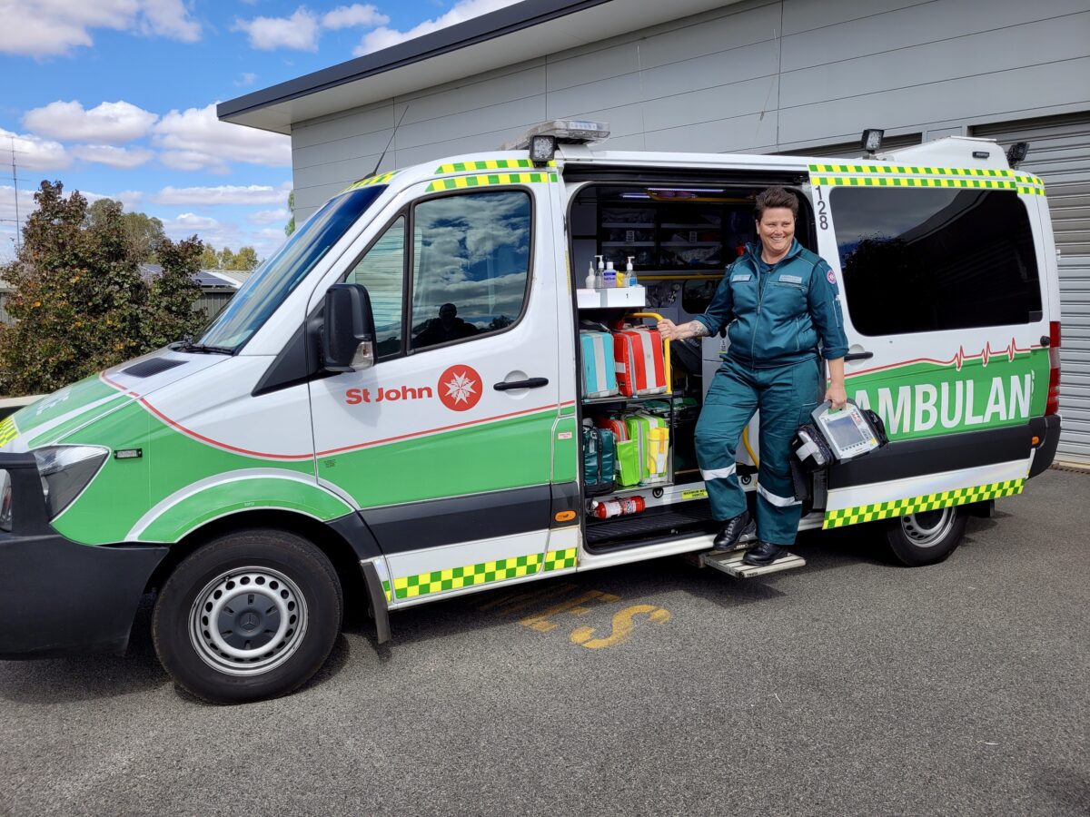 An image of a St. John van and a paramedic