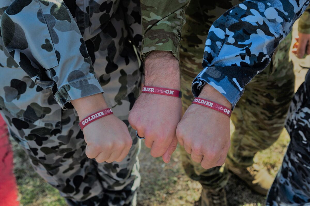An image of three Soldier On soldiers' hands