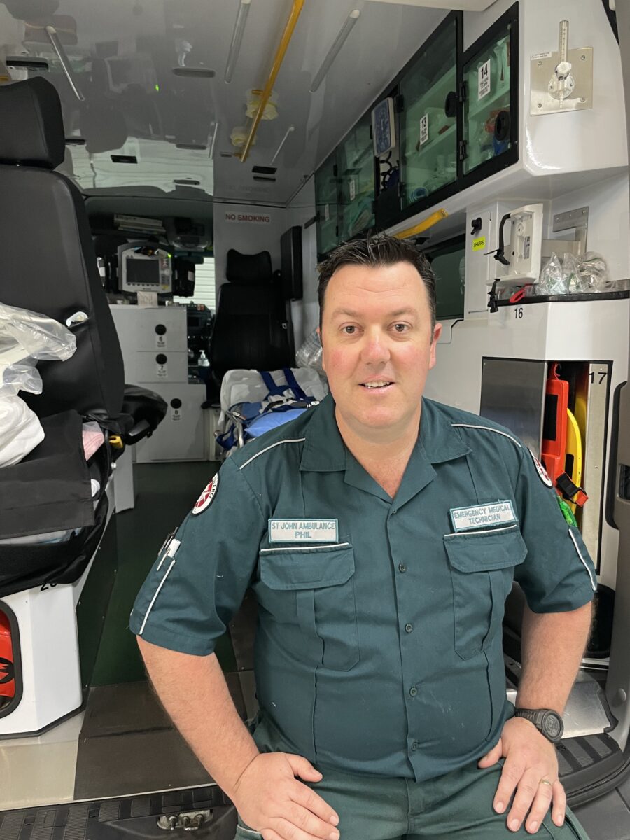 An image of Phillip Stewart  in front of an ambulance